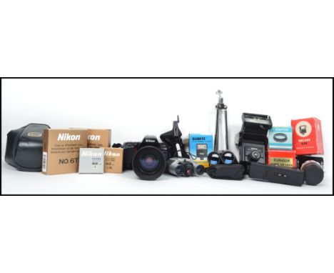 A group of vintage photography equipment to include a Nikon N70/F70 SLR and lens, Boxed flashed, Vivitar, binoculars etc.