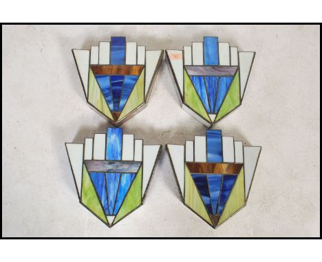 A set of four vintage 20th century Art Deco style stained glass panelled light fixture wall mounted pockets of stepped form. 