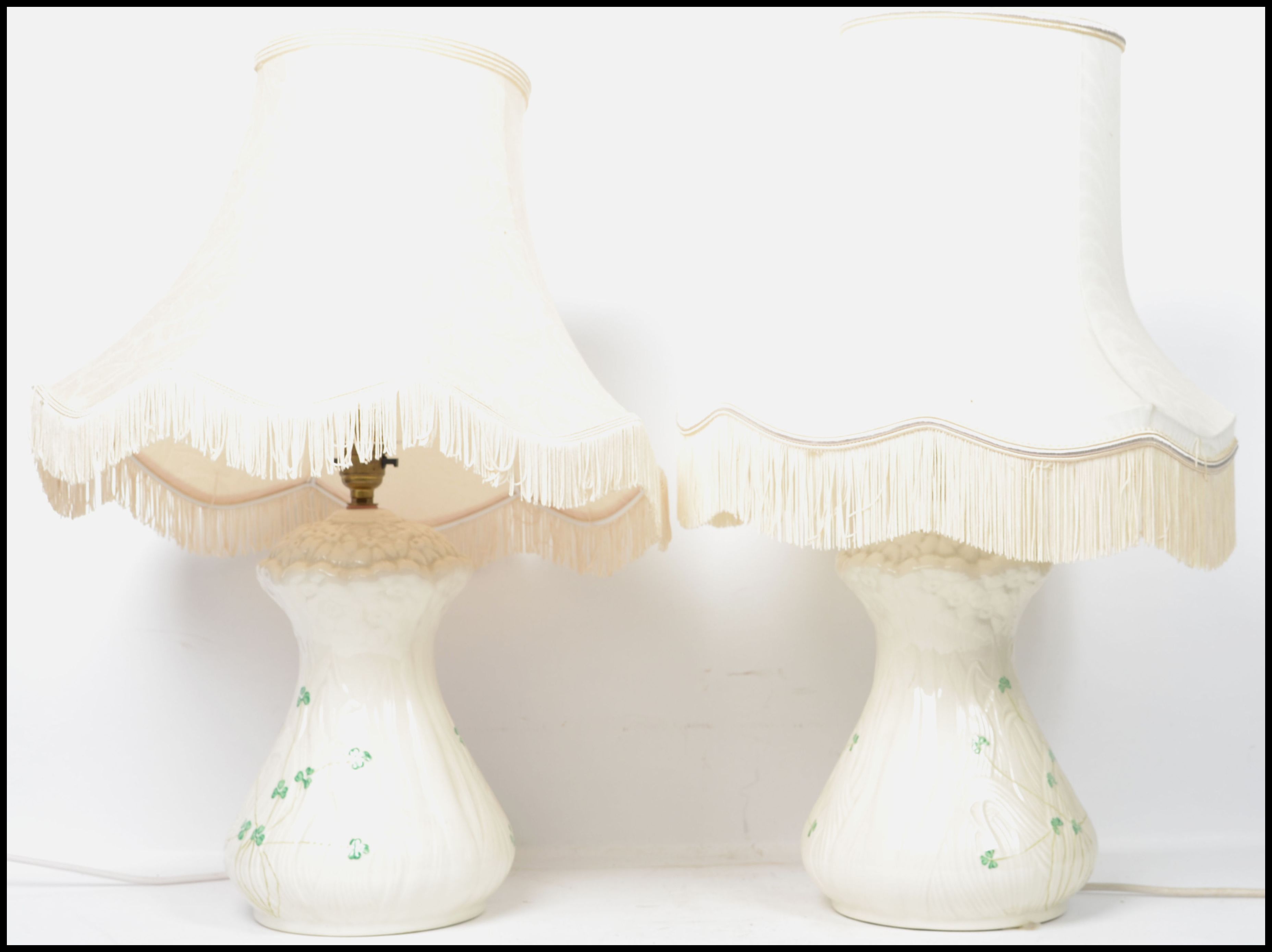 A pair of Irish 20th century Belleek ceramic table lamps decorated in