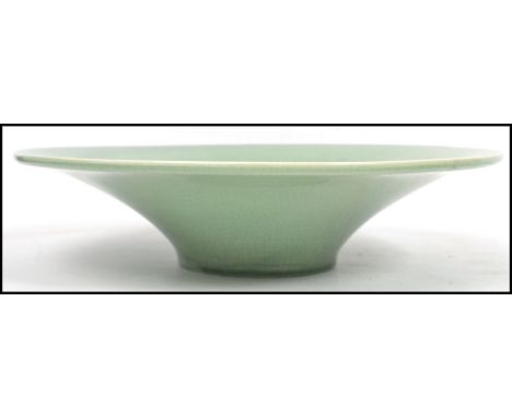 A Chinese /  Oriental ceramic celadon crackle glaze bowl of large tapering form. Measurements: 9 cm high and 36 cm diameter. 