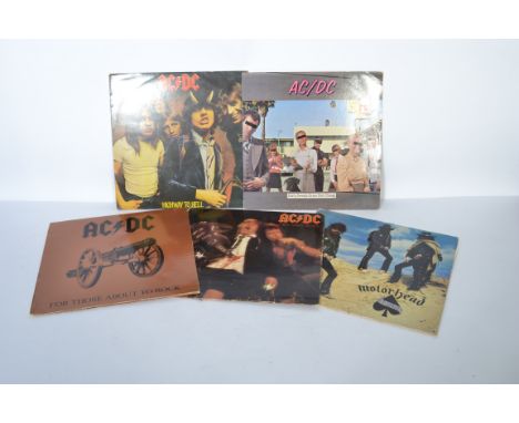 A collection of five vintage long play LP vinyl record rock albums to include AC/DC x four records and an LP by Motorhead.