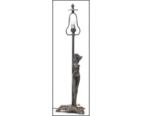 A 20th century art deco style bronze effect table lamp raised on a rococo influence tripod base having a central column with 