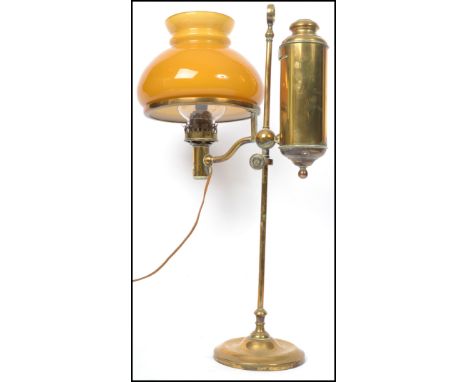 An early 20th century Argand and Co brass coaching  lamp complete with orange glass shade. Measures: 57cm high x 33cm deep x 