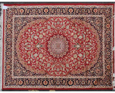 A large Iranian / Persian Keshan carpet - rug having red  ground with geometric decoration and borders. Measures 1.90m x 1.40