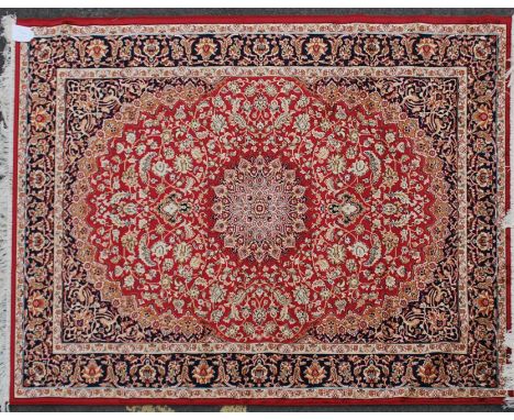 A large Iranian / Persian Keshan carpet - rug having red  ground with geometric decoration and borders. Measures 1.90m x 1.40