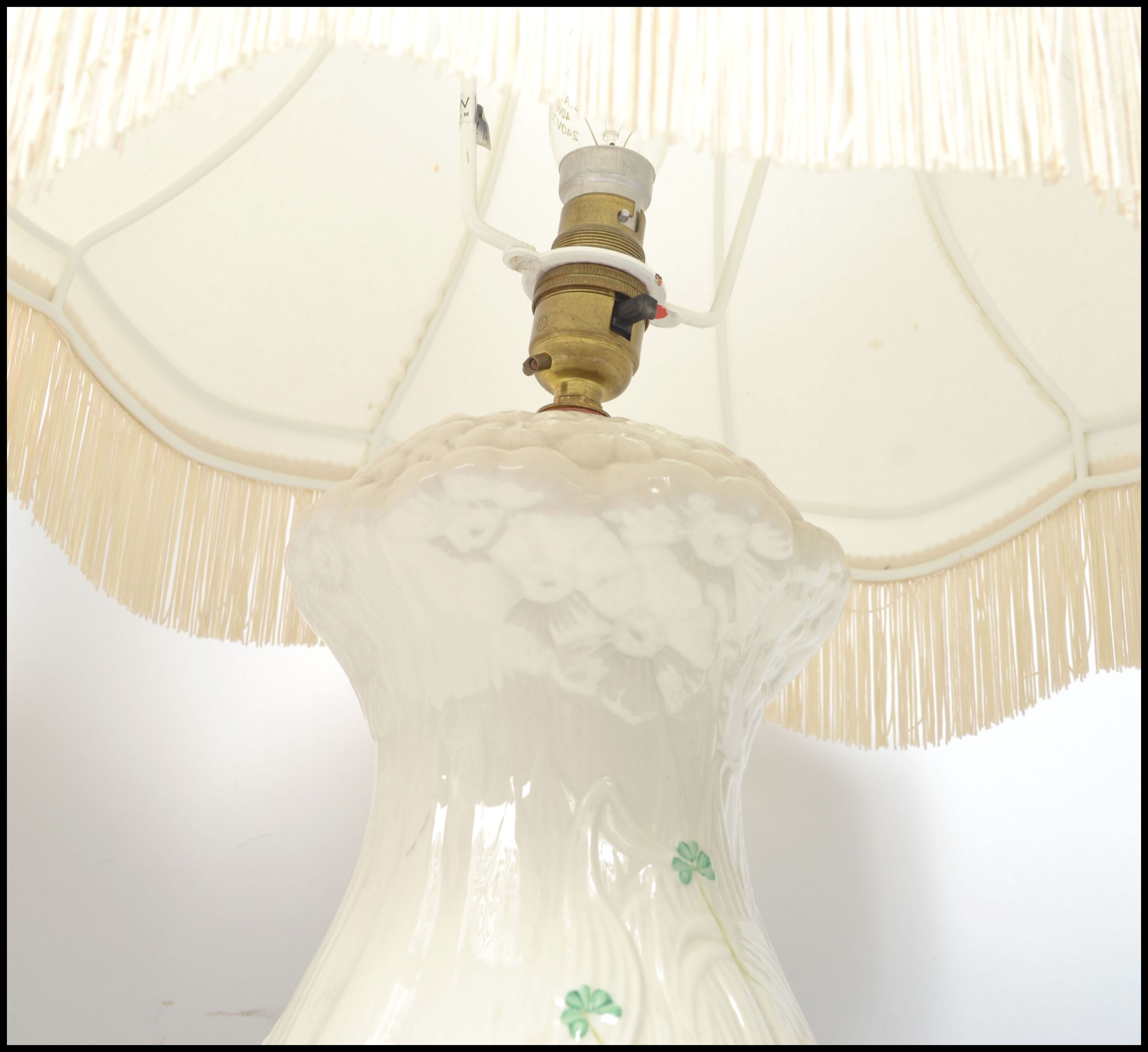 A pair of Irish 20th century Belleek ceramic table lamps decorated in