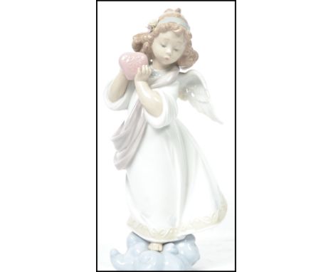 A Lladro ceramic figurine entitled ' Loving The World '  depicting an angel with flowers to hair raised on a cloud base holdi