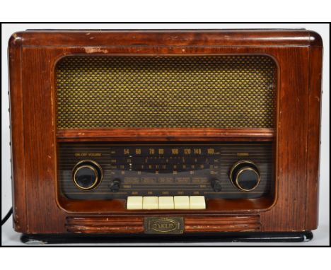 A vintage style reproduction electrical valve wooden cased radio with buttons and dials to front. Measurements: 27 cm high, 4