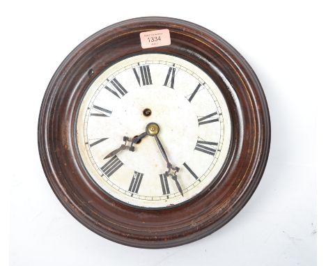 A vintage 20th century station clock having an enamel face with faceted hands and a Roman numeral chapter ring with faceted h