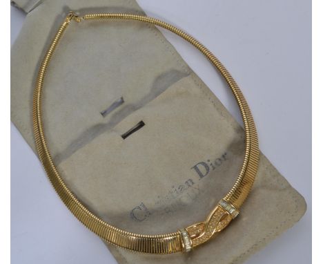 A 20th century Christian Dior Bijoux goldtone necklace set with rhinestones Marked to foldover clasp. Comes with original sue