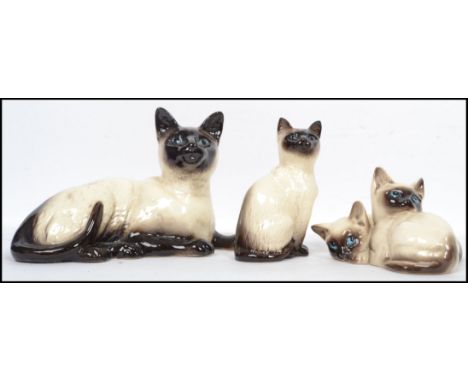 A group of vintage ceramic cats to include a Royal Doulton 1296 a Beswick 1887 and a Beswick 1559. Measures: 11cm high x 12 d