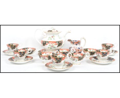 A good early 20th century tea service in an Imari pattern with bubble decorations. The set comprising large teapot, cups, sau