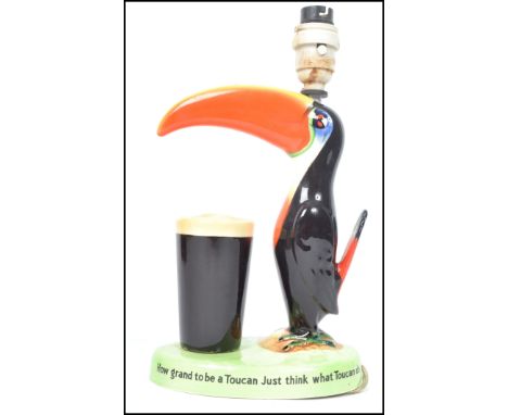 An original Guinness advertising Carlton ware Guinness lamp base, modelled as a Toucan with advertising verse printed around 
