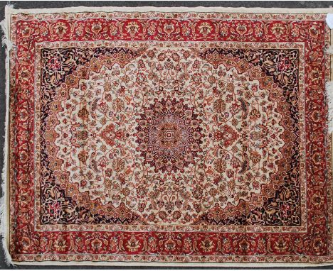 A large North Western Iranian / Persian Heriz carpet - rug having red and beige ground with geometric decoration and borders.