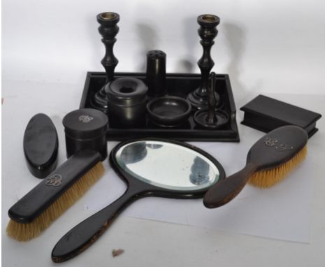A vintage early 20th century ebonised ladies dressing table set to include brushes, hand mirror, ring stand, tray etc.