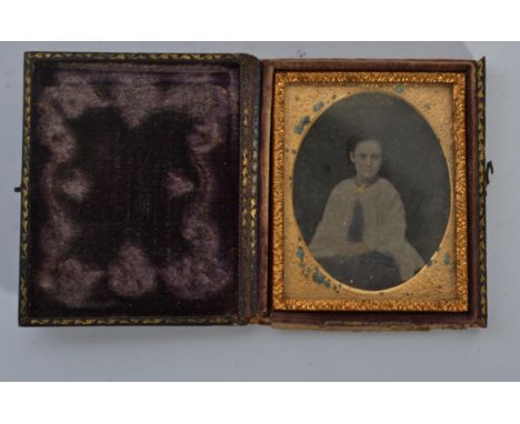 A 19th century Victorian ambrotype of a girl set in an ornate gilt frame housed within the original leather box with notation