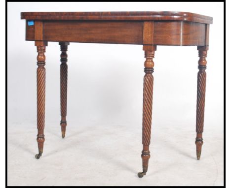 A 19th century Regency revival mahogany tea table / games card table being raised on turned legs with fitted frieze and flip 
