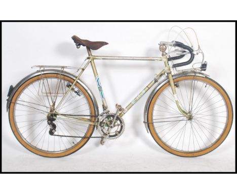 A vintage 1960's gents French eight speed touring bike, leather saddle, gear levers to frame, carrying racks with applied lab