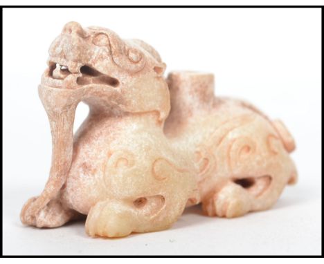 A beileved 19th / 20th century well carved white mutton Jade Chinese temple lion - fu dog being finely detailed with 4 claws 