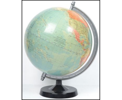 A retro 20th century vintage 1978 political desk top globe being raised on an ebonised plinth base.