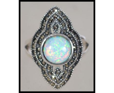 A silver Art Deco style ladies dress ring having a large central opal surrounded by marcasite's/ Size O / Weight 5.6g