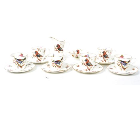 A 1920's Royal Doulton ceramic coffee service consisting of cups saucers, creamer jug and sugar bowl decorated with Exotic bi