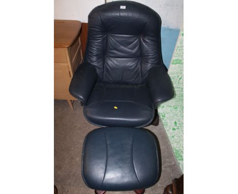 A LEATHER ARM CHAIR AND STOOL 