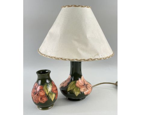 MOORCROFT TABLE LAMP & VASE, both in green Hibiscus, lamp 19cms high (excluding shade), vase 13cm high (2)Comments: chip to f