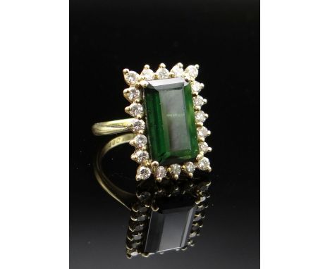 18CT GOLD GREEN TOURMALINE & DIAMOND CLUSTER RING, the central green tourmaline (13 x 8mms) surrounded by twenty diamonds, ri