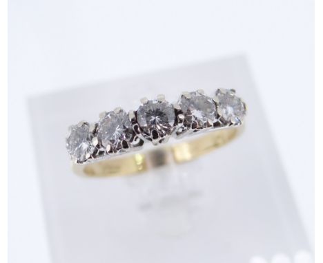 FIVE-STONE DIAMOND RING, set with circular brilliant cut stones to an 18ct yellow gold shank stamped 750 and import marks for