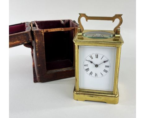 GILT BRASS CORNICHE CASE CARRIAGE CLOCK, late 19th Century, with original travelling case, the case with shaped handle over a