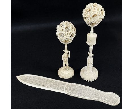 TWO CHINESE IVORY PUZZLE BALLS &amp; PAGE TURNER, with sectional stands, one with monkey holding a peaches, 21cms h (ball 6.5