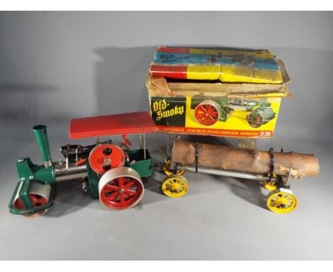 Wilesco - A Wilesco D36 live steam 'Old Smokey' steam roller traction engine in green and red with a Mamod Log Trailer. [2]