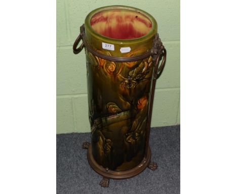 A Bretby pottery stick stand decorated with dragons and with gilt metal mounts, ring and lion mask handles and paw feet, impr