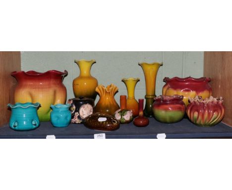 A shelf of Bretby pottery including jardinieres, vases etc