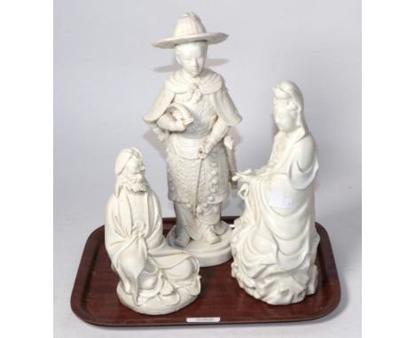 A Chinese blanc-de-chine figure of a young warrior, 19th century, a seated Guanyin with scroll, and a figure of a seated bear