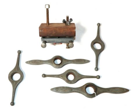 Five Rolex case back opening tools and a Rolex watch clamp 