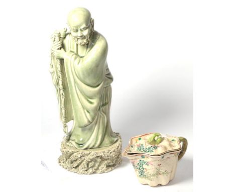 A Chinese celadon glazed figure of an immortal with a ceramic gourd-form teapot (2) 