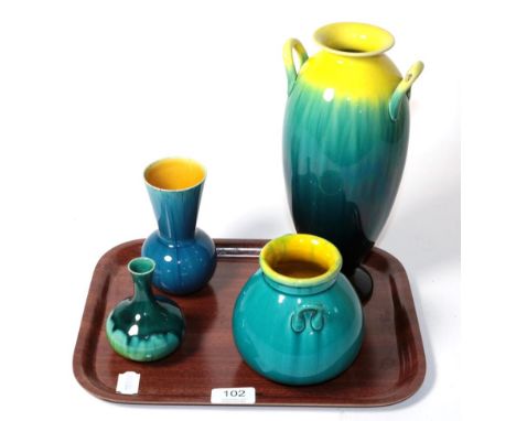 Four Linthorpe pottery vases including two twin-handled examples, all with a turquoise glaze, numbers 1309, 2172, 845 and 821