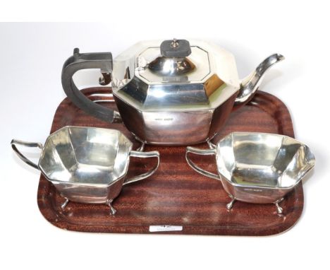 A three piece silver tea service, Harrison Fisher &amp; Co, Sheffield 1945, the teapot 25.5cm long, 38ozt (3) 