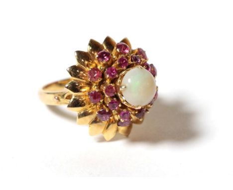 An opal and ruby cluster ring, a round cabochon opal within a border of round cut rubies and a petal surround, finger size J1