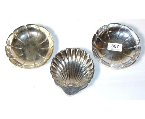 A pair of small strawberry type dishes, HB, London 1968; and a silver butter shell, George Howson, Sheffield 1911, the pair 1