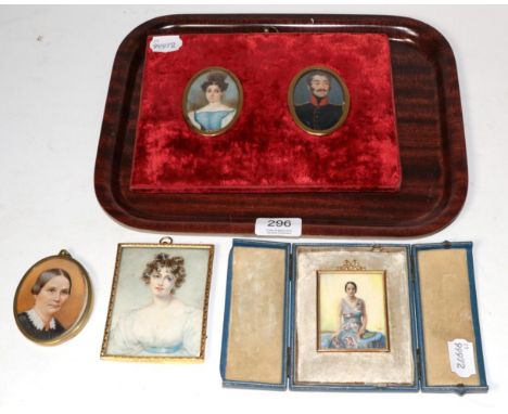 A pair of 19th century portrait miniatures of a gentleman in military dress; and a lady, unsigned; together with two later mi