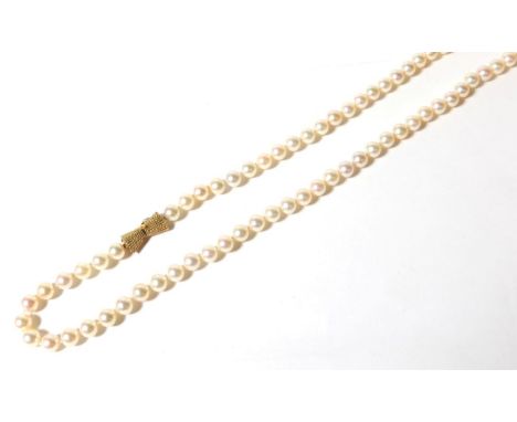 An Akoya cultured pearl necklace with a bow shaped clasp , length 91cm, stamped '14K'