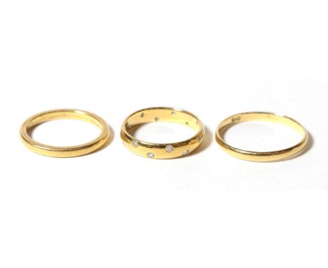 Two yellow metal band rings, finger sizes M and R; and a diamond set 18 carat gold band ring, finger size K1/2 (3) .  Two ban