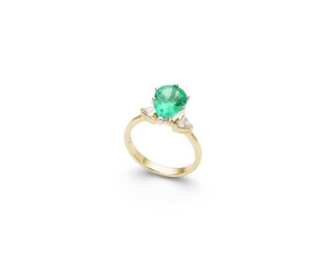 An emerald and diamond ring claw-set with a pear-shaped emerald, flanked to either side by a triangular-cut diamond, stamped 