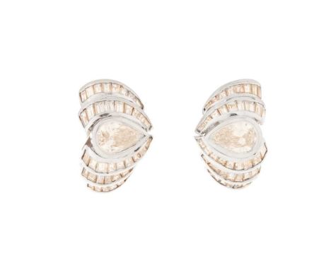 A pair of diamond earrings each collet-set with a pear-shaped diamond in a surround of channel-set baguette-cut diamonds, pos