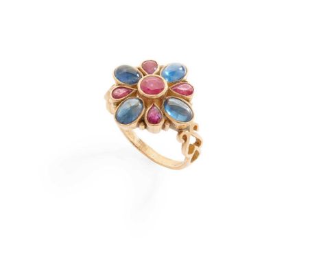 A ruby and sapphire cluster ring collet-set with round and pear-cut rubies and oval cabochon sapphires, modelled in 18ct gold