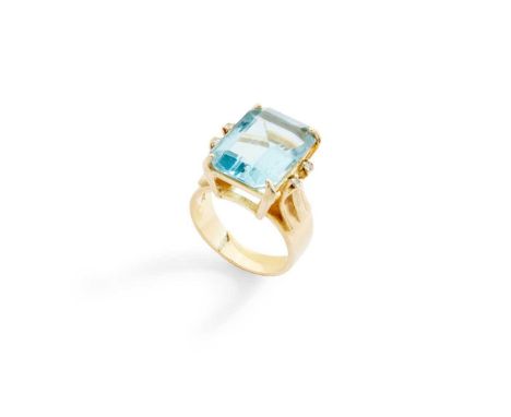 A blue topaz and diamond ring claw-set with a cut-cornered rectangular-cut blue topaz, each shoulder set with two small round