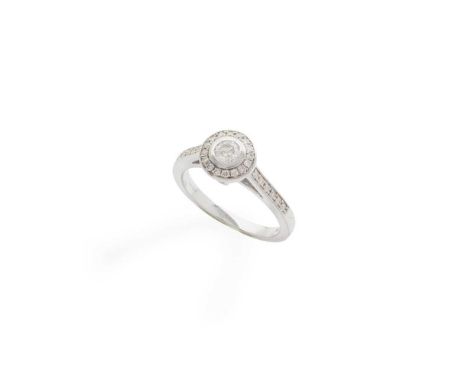 A diamond ring collet-set with a round brilliant-cut diamond in a border of smaller round brilliant-cut diamonds, modelled in